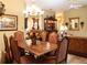 Formal dining room featuring a large wood table and comfortable seating for six at 4707 River Ridge Dr, Leesburg, FL 34748