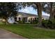 Side view of home with landscaping and large trees at 4707 River Ridge Dr, Leesburg, FL 34748