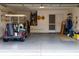 Attached garage with golf cart, storage shelving, and ample space at 4707 River Ridge Dr, Leesburg, FL 34748