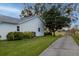 Well-maintained house exterior with side yard and paved driveway at 4707 River Ridge Dr, Leesburg, FL 34748