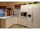 Kitchen boasts white cabinets, new flooring and a corner sink at 4707 River Ridge Dr, Leesburg, FL 34748