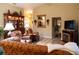 Living room with leather furniture, hardwood floors, and built-in shelving at 4707 River Ridge Dr, Leesburg, FL 34748