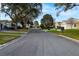 Residential street with houses and trees, golf cart crossing at 4707 River Ridge Dr, Leesburg, FL 34748