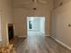 Open living room and adjacent dining area with light gray wood-look floors at 5021 Se 109Th Pl, Belleview, FL 34420