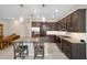 Modern kitchen with dark cabinetry, granite counters, and island at 5403 Nw 33Rd Pl, Ocala, FL 34482