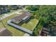 An aerial view of the home's backyard, showing a large shed and fenced area at 6931 Se 54Th St, Ocala, FL 34472