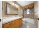 Bathroom with patterned tile shower/tub combo and updated vanity at 6931 Se 54Th St, Ocala, FL 34472