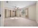Bedroom with ceiling fan, large closet, and neutral carpet at 6931 Se 54Th St, Ocala, FL 34472