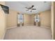 Bright bedroom with ceiling fan, neutral carpet, and dual windows at 6931 Se 54Th St, Ocala, FL 34472