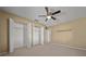 Spacious bedroom with ceiling fan, large closet, and neutral carpet at 6931 Se 54Th St, Ocala, FL 34472