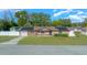 One-story home with solar panels, landscaped yard, and detached shed at 6931 Se 54Th St, Ocala, FL 34472