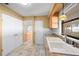Kitchen with double sink, light wood cabinets and pantry at 6931 Se 54Th St, Ocala, FL 34472