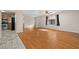 Bright living room with wood-look floors and access to kitchen at 6931 Se 54Th St, Ocala, FL 34472