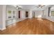 Open concept living room with hardwood floors and multiple ceiling fans at 6931 Se 54Th St, Ocala, FL 34472