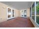 Screened porch with double doors leading inside at 6931 Se 54Th St, Ocala, FL 34472