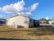 Side view of manufactured home with screened porch at 816 Hibiscus Dr, The Villages, FL 32159