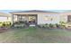 Home features a screened patio, landscaped yard, and grassy area at 9002 Sw 75Th Loop, Ocala, FL 34481