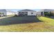 House with a screened-in patio and a large grassy backyard at 9002 Sw 75Th Loop, Ocala, FL 34481