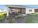 Screened patio with seating area and landscaped backyard at 9002 Sw 75Th Loop, Ocala, FL 34481