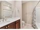 Bathroom with shower and tub, vanity with dark wood cabinets, and a toilet at 9002 Sw 75Th Loop, Ocala, FL 34481