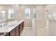 Modern bathroom with double sinks, large mirror, and walk-in shower at 9002 Sw 75Th Loop, Ocala, FL 34481
