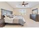 Bright bedroom with large window, ceiling fan, and neutral color palette at 9002 Sw 75Th Loop, Ocala, FL 34481