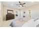 Spacious bedroom with carpeted floor, ceiling fan, and ensuite bathroom access at 9002 Sw 75Th Loop, Ocala, FL 34481