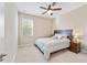 Comfortable bedroom with ceiling fan, window, and bedside table at 9002 Sw 75Th Loop, Ocala, FL 34481