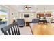 Open concept living and dining space with comfortable seating, a dining table, and a large TV at 9002 Sw 75Th Loop, Ocala, FL 34481