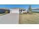 One-story house with gray exterior, two-car garage, and well-manicured lawn at 9002 Sw 75Th Loop, Ocala, FL 34481