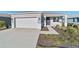 One story home with gray exterior, two car garage, and landscaped yard at 9002 Sw 75Th Loop, Ocala, FL 34481
