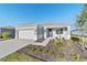 One-story home with gray exterior, two-car garage, and landscaped front at 9002 Sw 75Th Loop, Ocala, FL 34481