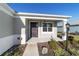 Front porch with dark-colored door and landscape at 9002 Sw 75Th Loop, Ocala, FL 34481