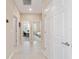 Bright hallway with tile flooring and access to bedrooms and office at 9002 Sw 75Th Loop, Ocala, FL 34481