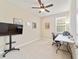 Bright home office with a large TV, desk, and comfortable chair at 9002 Sw 75Th Loop, Ocala, FL 34481
