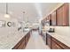 Modern kitchen with granite countertops, stainless steel appliances, and an island with seating at 9002 Sw 75Th Loop, Ocala, FL 34481