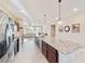 Modern kitchen with granite countertops, stainless steel appliances, and an island with seating at 9002 Sw 75Th Loop, Ocala, FL 34481