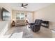 Bright living room features a neutral color palette, comfortable seating, and large windows at 9002 Sw 75Th Loop, Ocala, FL 34481