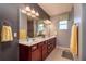 Elegant bathroom featuring double sinks and a large mirror at 9257 Sw 94Th Loop, Ocala, FL 34481