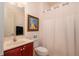 Clean bathroom with a toilet, sink, and shower/tub combo at 9257 Sw 94Th Loop, Ocala, FL 34481