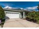 White two-car garage with driveway and landscaping at 9257 Sw 94Th Loop, Ocala, FL 34481