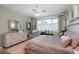 Spacious main bedroom with king-size bed and large dresser at 9257 Sw 94Th Loop, Ocala, FL 34481