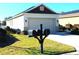 Home exterior showcasing a three-mailbox post and a two-car garage at 9871 Sw 99Th Loop, Ocala, FL 34481