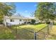 Large backyard with a chain link fence, lush lawn, and patio at 10195 Se 178Th Pl, Summerfield, FL 34491