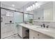 Updated bathroom features a walk-in shower, double vanity, and modern finishes at 10195 Se 178Th Pl, Summerfield, FL 34491