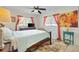 Bright bedroom with a queen-size bed, ceiling fan, and large windows at 10195 Se 178Th Pl, Summerfield, FL 34491