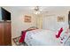 Cozy bedroom with a full-size bed, red bedding, and ample closet space at 10195 Se 178Th Pl, Summerfield, FL 34491