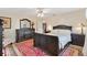 Spacious bedroom with dark wood furniture and a large bed at 10195 Se 178Th Pl, Summerfield, FL 34491