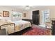 Main bedroom with a dresser, carpet, and ensuite bathroom access at 10195 Se 178Th Pl, Summerfield, FL 34491