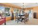 Casual dining area with wood table and chairs, near the kitchen and backyard access at 10195 Se 178Th Pl, Summerfield, FL 34491